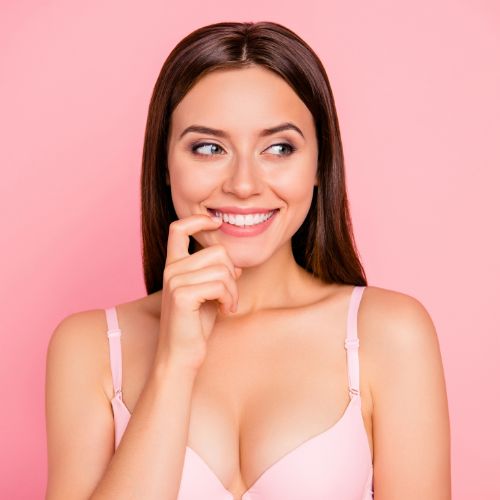 Breast Augmentation vs. Breast Lift: What's the Difference? 1 cheerful girl in beige bra